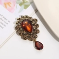 Detail of vintage flower brooch with amber crystal teardrop and champagne rhinestones - Amber