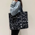 Large black canvas tote bag featuring a white cat print and wide shoulder strap - MIMI Cat - Black