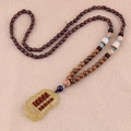 Ethnic wood bead necklace featuring a topaz abacus pendant and blue decorative accents - Resin Abacus