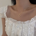 Detailed view of golden snake chain with a rectangular hammered textured pendant - Layering Style 4