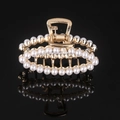 Detail of a golden metal hair claw clip featuring rows of white pearls on a black background - Gold Full Pearl Oval Claw Clip
