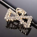 Elegant gold bow hair claw clip with sparkling white rhinestones on black background - Gold Full Rhinestone Bow Claw Clip