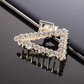 Macro shot of gold-plated hair claw clip with triangle design and shimmering rhinestones - Gold Full Rhinestone Triangle Claw Clip