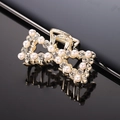 Detail of gold bow hair claw clip featuring white faux pearls and sparkling rhinestones - Gold Rhinestone & Pearl Bow Claw Clip