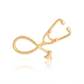 Macro detail of polished gold stethoscope brooch pin with reflective surface on white background - Gold