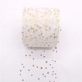 Detail of white tulle ribbon roll with sparkling gold star patterns for DIY crafts - White