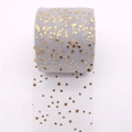 Detail of grey tulle fabric roll with gold foil star patterns for DIY hair accessories - Gray