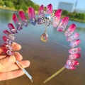 Detail of pink and purple gradient crystal crown with silver sun totem and drop pendant - Blue Red/Sun/AB Colorful Pendant