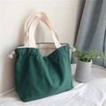 Detail of dark green canvas tote bag featuring thick fabric and drawstring closure - Dark Green