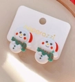 Close-up of resin snowman earrings with red hats and striped scarves on a white card - Style 7 Snowman Clip