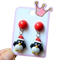 Detail of Christmas penguin clip-on earrings with red festive hats on white card - Style 22 Christmas Penguin Dangle
