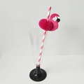 Detailed view of pink striped paper straw with a flamingo honeycomb decoration in a glass - Rose Pink Flamingo