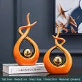 Modern orange and gold ceramic sculptures set for home decor on stylish display - Morning Song Style Orange Gold Pair - Large