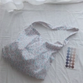 Detailed view of floral cotton fabric texture and wide shoulder strap on tote bag - White Pink Floral