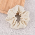 Detailed texture of off-white seersucker scrunchie with bubble pattern fabric - Pleated Cloth Style / Off-white Pleated Scrunchie