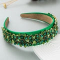 Detailed view of emerald green baroque headband with intricate rhinestone flower patterns - Green