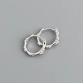 Macro detail of silver bamboo-style earrings with sparkling micro-stone accents - Bamboo Joint Hoop Earrings (S-E1555) / Silver
