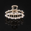 Close-up of golden metal hair claw clip with white pearls and sparkling rhinestones - Gold Rhinestone & Pearl Oval Claw Clip