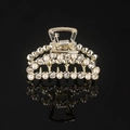 Detail of gold hair claw clip with inlaid pearls and sparkling rhinestones on black background - Gold Rhinestone & Pearl Small Moon Claw Clip