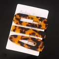 Detail shot of the tortoise shell acetate hair clip set showing unique patterns and textures. - Tortoise Shell Acetate Set