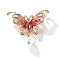 Elegant gold-tone butterfly brooch with red enamel wings, rhinestones, and a pearl drop - Red