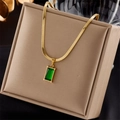 Close-up of emerald green rectangular pendant with golden snake chain on a luxury display box - Necklace (Snake Bone Chain + Green Gemstone Pendant)