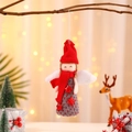 Close-up of a Christmas angel ornament with red knit hat and white plush wings - Red Hat Red Scarf Angel