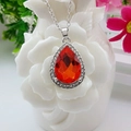 Silver necklace featuring a large red pear-shaped gemstone pendant with sparkling rhinestones - Single Necklace / Lotus Red