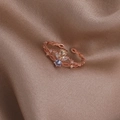 Macro shot of rose gold crown ring with pear-shaped yellow gems on silk fabric - Blue Three-Petal Flower (Rose Gold) (21701B)