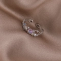 Macro shot of silver pearl shell flower ring with purple gemstone and zircon on brown silk - Pink Rhinestone Twisted (Silver) (21702C)