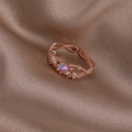 Macro view of rose gold floral ring with pearls and crystals on brown silk background - Pink Rhinestone Twisted (Rose Gold) (21702A)
