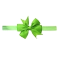 Close-up of bright green grosgrain ribbon bow with elastic band for baby hair - Green