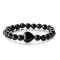 Macro detail of deep blue goldstone beaded bracelet with central heart-shaped stone - Blue Sandstone
