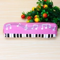 Detail view of pink music pencil case featuring white notes and piano key patterns - Pink