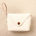 Detail of cream envelope coin purse with vintage bronze snap button and wrist strap - White