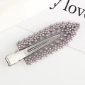 Detail of silver hair clip with purple pearls and rhinestones on a decorative card - Gray