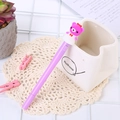Purple unicorn light-up pen with cute bear topper on a decorative lace background - Light-up Skirt Bear Purple