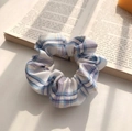 Blue and purple checkered organza scrunchie displayed on an open vintage book - Blue White Cotton Check