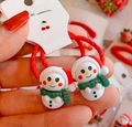 Handheld pair of red Christmas snowman hair elastics for girls festive hair accessories - Blue Hat Snowman