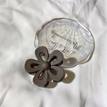Matte dark brown flower hair claw clip on a decorative tray for elegant hairstyling - 7*7*3.2cm / Brown