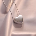 Polished silver heart pendant necklace on pink silk fabric, minimalist chic jewelry - Silver