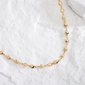 Minimalist gold heart chain necklace elegantly displayed on white textured stone background - Gold