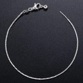 Elegant silver snake chain necklace with lobster clasp and bead pendant on black texture - Bracelet / White Gold