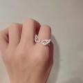 Detailed view of angel wing ring featuring micro-paved cubic zirconia crystals - White Gold