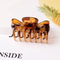 Close-up of a large amber tortoiseshell hair claw clip with a glossy finish on white backdrop - Tortoise / 6cm