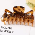 Macro detail of large amber leopard print hair claw clip with strong metal spring - Tortoise / 11.5CM