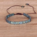 Macro detail of adjustable hematite arrow bracelet with hand-woven brown nylon cord - Rainbow Arrow / Green