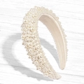 Detailed view of wide headband with varying sizes of white pearls and beige lining - Off White / US 13.5