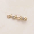Close-up of gold alloy hair clip featuring alternating pearls and shimmering crystals - Rhinestone Pearl Heart Style