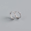 Macro detail of S925 sterling silver hoop earrings with a twisted wire texture design - 925 Silver / White Gold